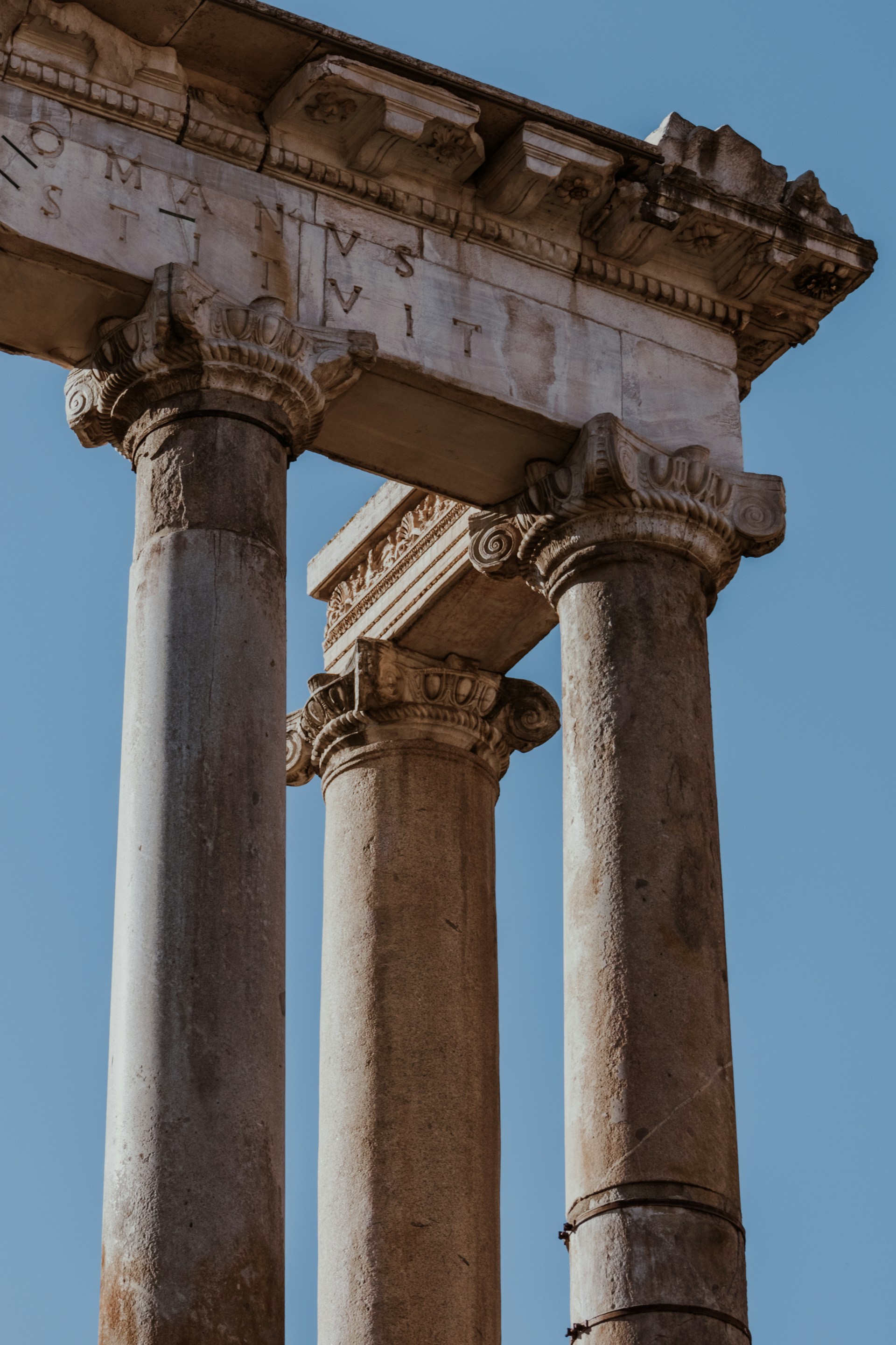 Ancient Roman corner pillar among three columns, symbolizing the foundational structure of The Three-Pillar Method
